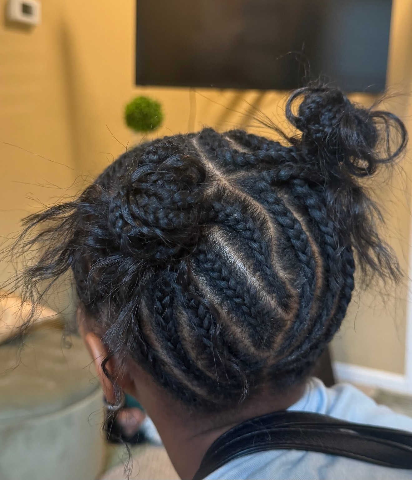 A finished braided style by Braids at Your Door