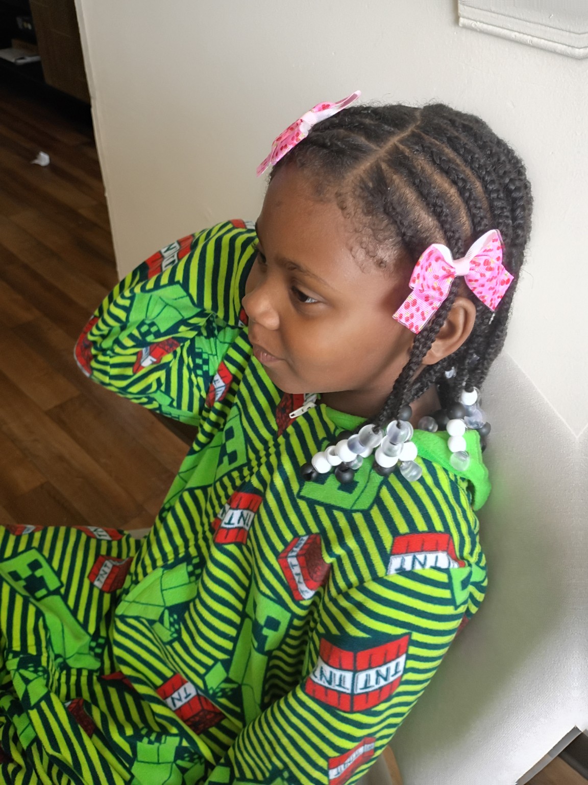 Children’s braided style with pink bows and beads